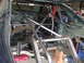 1992 Ford Mustang - The interior of a car is visible, heavily modified with a roll cage and stripped-down components.