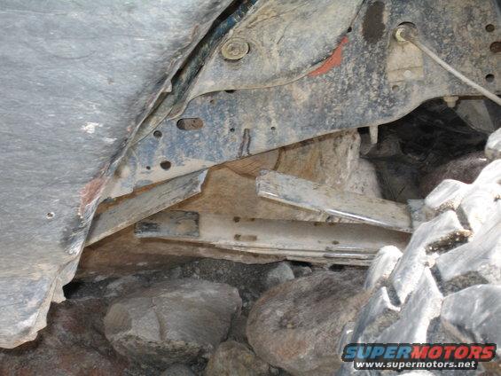 Undercarriage detail with tire and rocks