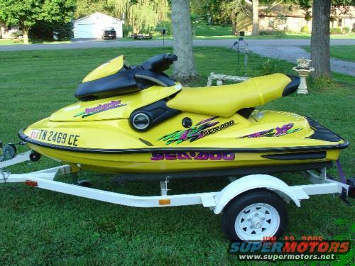 Yellow jet ski with 'Bombardier Sea-Doo XP' graphics on a trailer. License plate reads TN 2469 CE