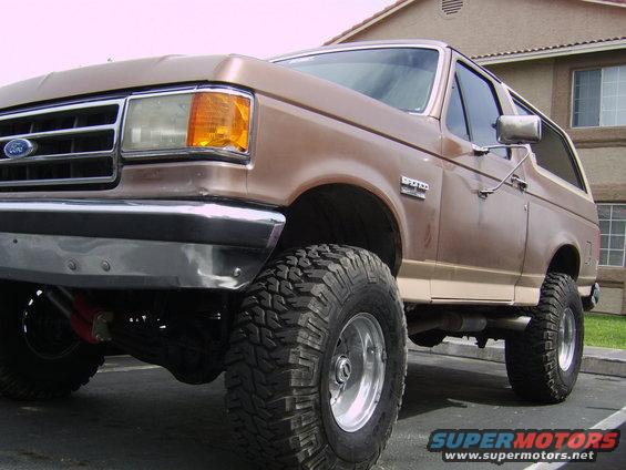 Brown Ford Bronco with lifted suspension and large tires