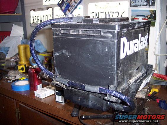 Car battery with blue braided cables attached