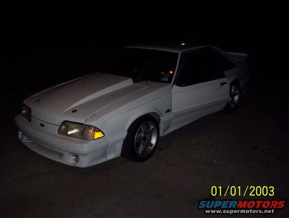 White 1991 Ford Mustang coupe with hood scoop, 3/4 front view