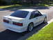 1991 Ford Mustang - Rear view of a white 1991 Ford Mustang hatchback with a spoiler.