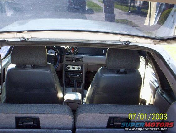 1991 Ford Mustang interior view from rear seats, showing dashboard and gauges