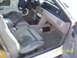 1991 Ford Mustang - The interior of a 1991 Ford Mustang shows the driver's side seat, dashboard, and center console with a water bottle on the seat.