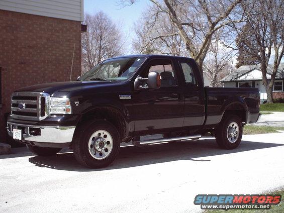 Black pickup truck, 3/4 front view. Grille indicates a 2005 model year