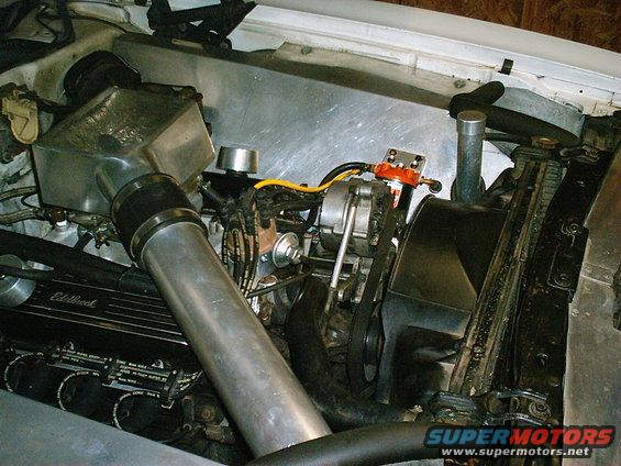 Engine bay with aluminum intake, Edelbrock valve covers, and visible alternator