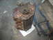 1997 Ford Crown Victoria - A rusty engine block sits on a scale in a garage.