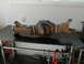 1996 Ford Bronco - A rusty rear axle assembly, likely for a truck or SUV, is displayed on a workbench.