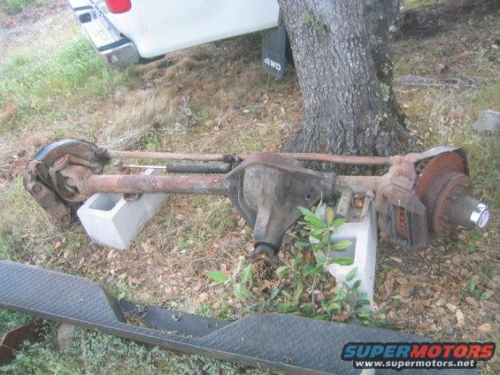 Ford truck rear axle assembly with disc brakes, resting on cinder blocks
