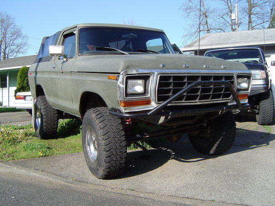 Olive green 1978 Ford Bronco 4x4 with brush guard and lifted suspension
