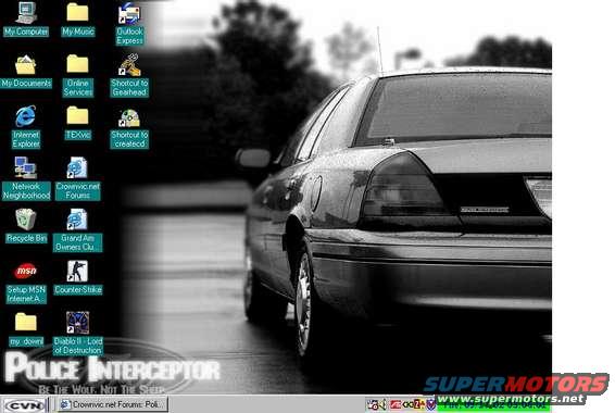 Rear view of a black Ford Crown Victoria Police Interceptor with 'POLICE INTERCEPTOR' text on the lower right