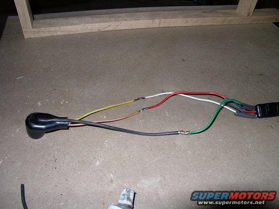 img_0429.jpg I whittled the back of the plug out to semi-recess the wire into the plug a bit and make it easier to glue in solid. Being from Mopars I used a weatherproof Mopar three wire quick disconnect plug (at the end of the wires soldered on).