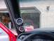 1989 Chevrolet Blazer - Interior view of aftermarket gauges installed in a vehicle, with a red truck visible in the garage behind.