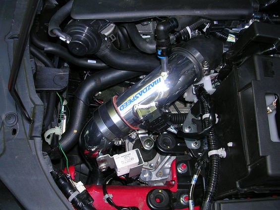 Mazdaspeed intake tube with blue lettering, connected to engine components