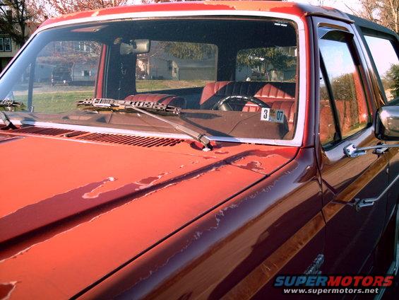 Red SUV interior with cracked dashboard and visible license plate reading 3 07