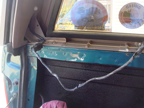 Wiring harness in teal truck bed, 1996 Ford Bronco