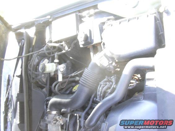 1996 Ford Crown Victoria engine bay with air intake and brake fluid reservoir visible