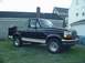 1993 Ford Bronco - This black 1993 Ford Bronco is shown from the side with its spare tire mounted on the rear.