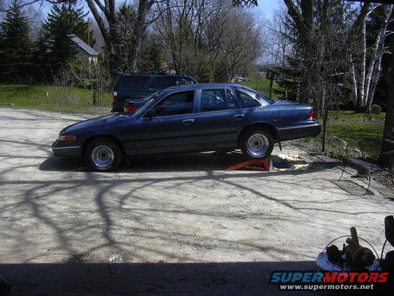 1996 Ford Crown Victoria on orange ramps in a driveway