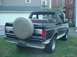 1993 Ford Bronco - Rear view of a 1993 Ford Bronco, showing its spare tire and removable top.