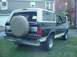 1993 Ford Bronco - This Ford Bronco is parked on a grassy lawn in front of a residential building.