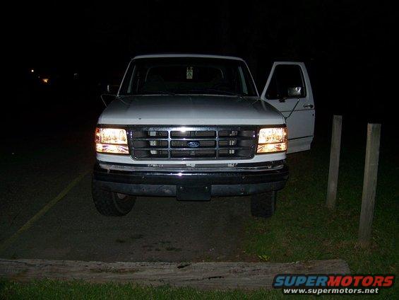 1995 Ford Bronco front view, headlights on, driver's door open