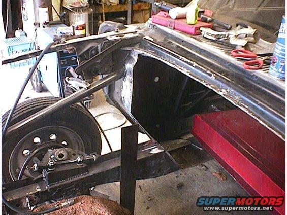 car frame, suspension, and wheel well in garage