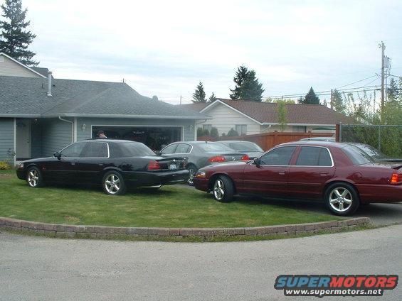 Maroon 2000 Ford Crown Victoria parked on grass, side view