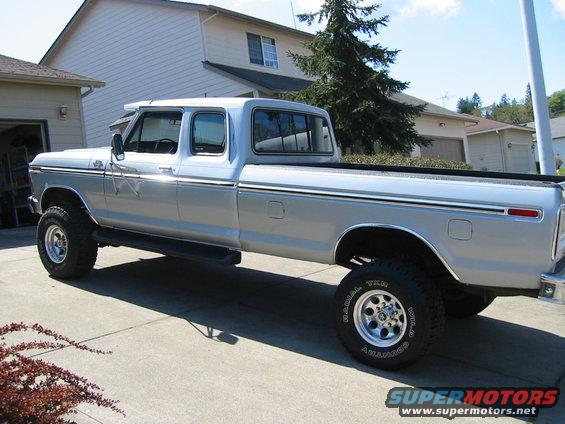 Silver crew cab pickup truck with aftermarket wheels and tires