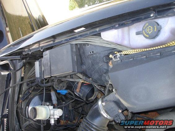Engine bay with brake fluid reservoir and fuse box visible