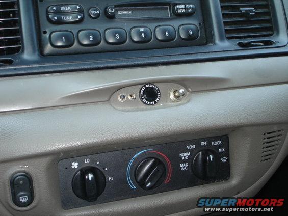 2001 Ford Crown Victoria interior dashboard with radio, climate controls, and a custom switch
