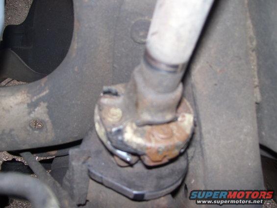 Rusty steering linkage component with Supermotors.net watermark