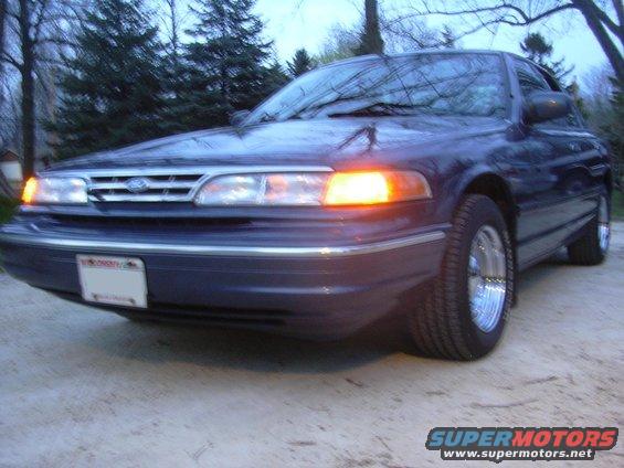 Dark blue 1996 Ford Crown Victoria front 3/4 view with amber turn signal on