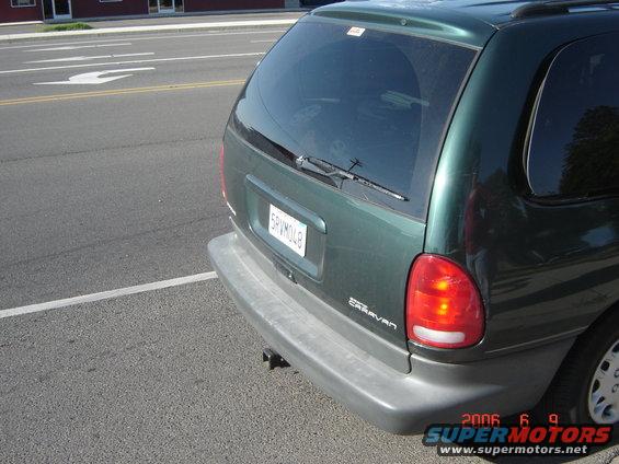 Green 1997 Dodge Grand Caravan rear view, showing bumper, taillight, and license plate