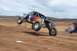 1992 Ford Explorer - Custom off-road buggy airborne during a jump on a dirt track.