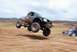 1992 Ford Explorer - A modified truck soars through the air during a race on a dirt track.