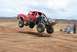 1992 Ford Explorer - A custom red off-road truck soars through the air during a race, displaying "Vengeance" graphics on its side.