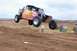 1992 Ford Explorer - This off-road buggy is captured mid-jump against a cloudy sky.