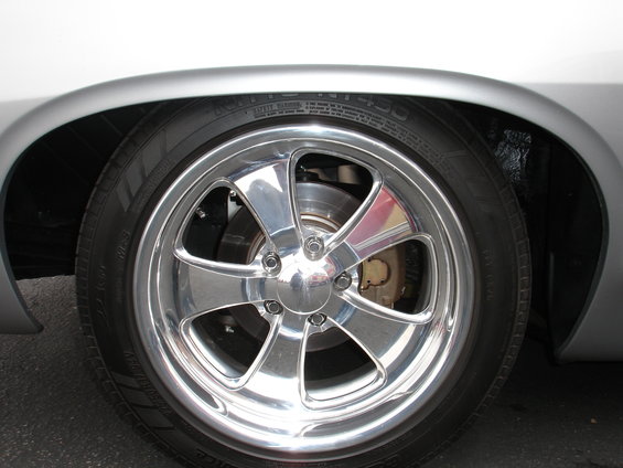 Chrome five-spoke wheel with tire and brake caliper