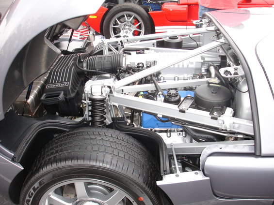 Silver Ford GT engine bay with a red Ford GT in the background
