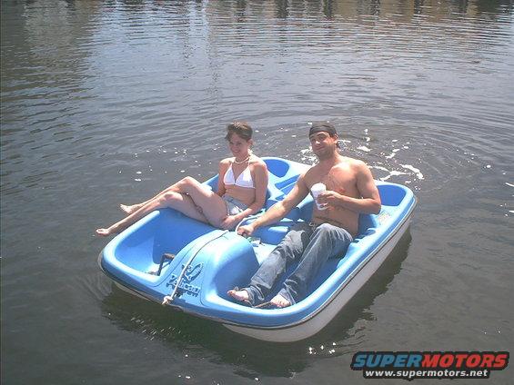 Blue and white pedal boat with a man and woman on a body of water