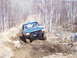 1996 Ford Bronco - Green 1996 Ford Bronco navigating a challenging muddy off-road course.