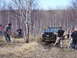 1996 Ford Bronco - People watch as a 1996 Ford Bronco gets stuck in the mud during an off-road excursion.