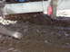 1996 Ford Bronco - Vehicle stuck in mud, with visible tire tracks and suspension parts.