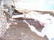 1996 Ford Bronco - Working on the undercarriage of a vehicle in the mud.