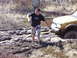 1996 Ford Bronco - A person attempts to pull a yellow SUV out of deep mud using a tow strap.
