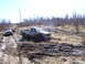 1996 Ford Bronco - Two trucks navigate a challenging muddy terrain, with one GMC pickup appearing stuck in the mire.