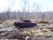 1996 Ford Bronco - A red pickup truck navigates a muddy off-road course, kicking up mud as it struggles through the terrain.