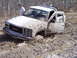 1996 Ford Bronco - A GMC pickup truck is stuck deep in the mud, with its doors open and a person observing the situation.